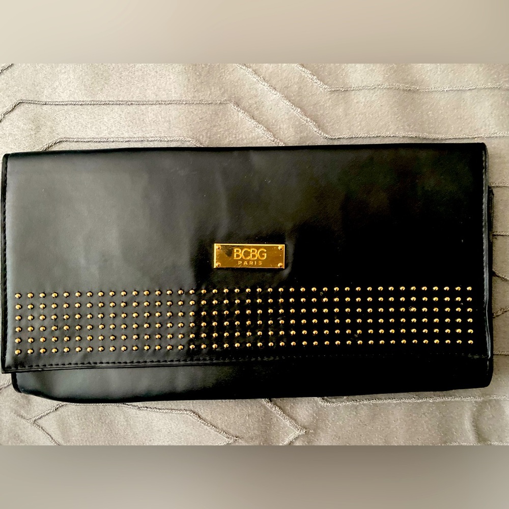 BCBG Clutch black with gold beads and label. Magnetic closure 6 1/2" x 11 1/2"